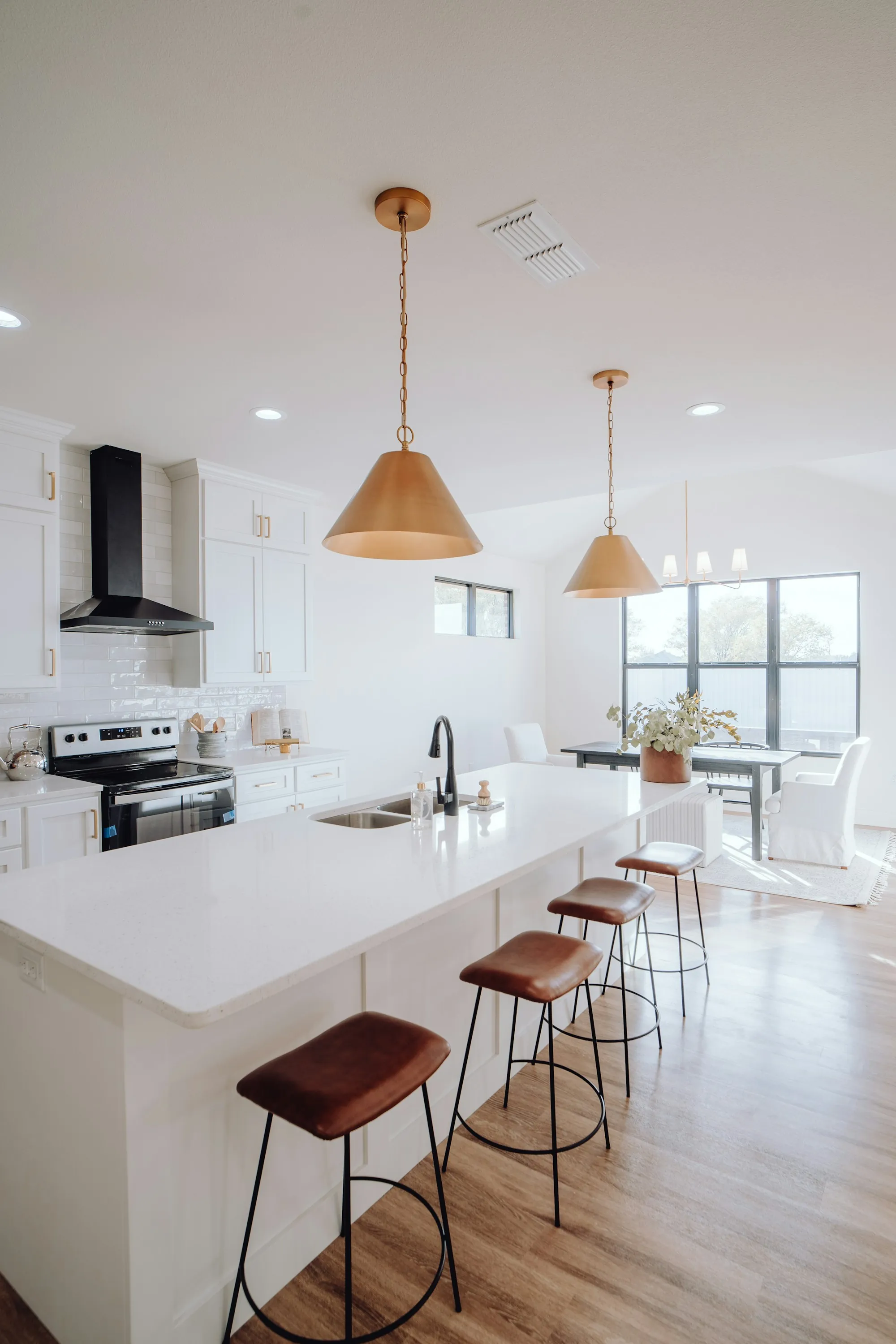 Remodeled kitchen with a long island, quartz counters and under-cabinet lighting